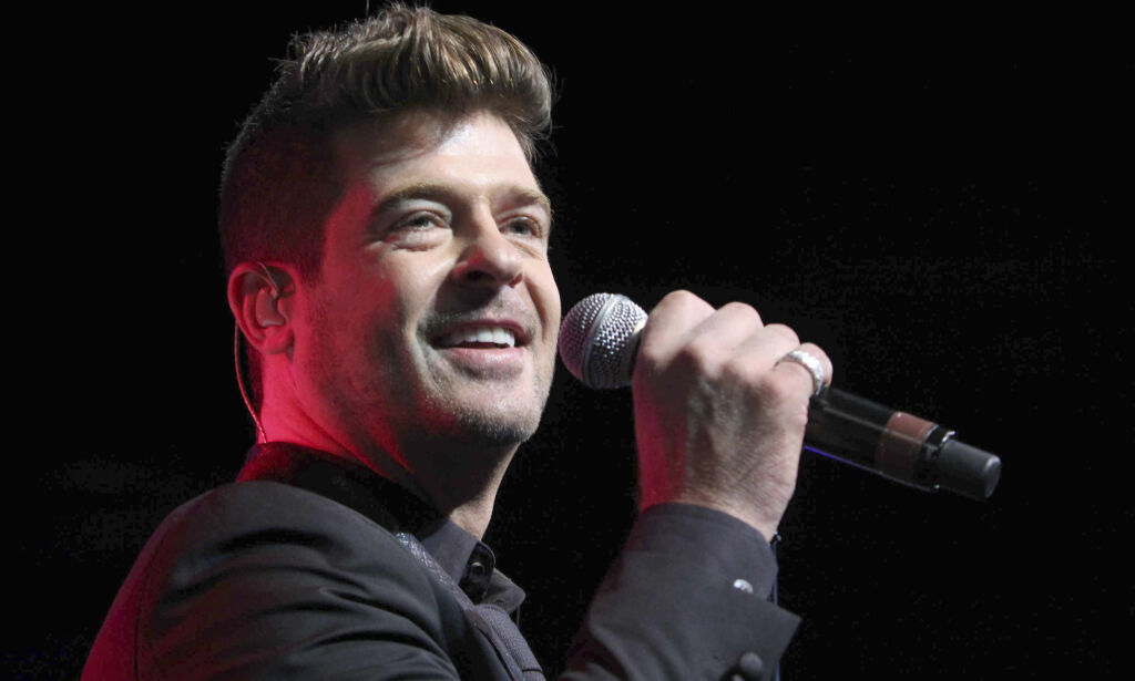 FILE - In this Aug. 7, 2015 file photo, Robin Thicke performs during the Steve Harvey Morning Show live broadcast at the Georgia World Congress Center in Atlanta. A judge has ordered Thicke to stay away from his ex-wife, actress Paula Patton and only have monitored visits with his 6-year-old son. Los Angeles Superior Court Judge Colin Leis issued the temporary restraining order on Thursday, Jan. 26, 2017, after Patton accused the singer of physically abusing her during their marriage, which ended in March 2015. (Photo by Robb D. Cohen/Invision/AP, File)
