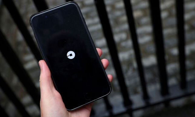 FILE PHOTO: The Uber logo is seen on mobile telephone in London, Britain, September 25, 2017. REUTERS/Hannah McKay/File Photo